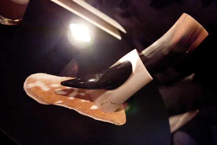 A boozy, meaty cocktail drunk from the horn - a pairing for neighboring Next restaurant's "The Hunt", meat-centric menu