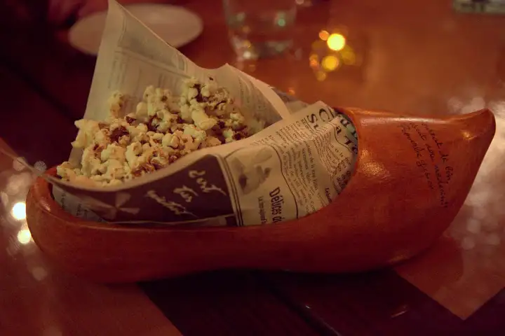 Smoked duck popcorn or calamari served in a traditional Gascon wooden shoe