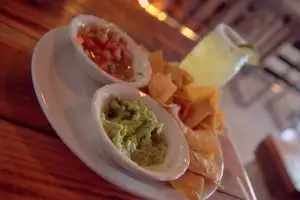 Guac, chips & margaritas in mason jars