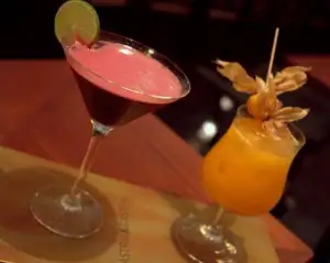 Astrid y Gaston cocktails made with purple corn (left) & aguaymanto (right)