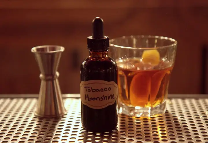 House "tobacco moonshine" goes into The Unforgiven cocktail made with Ransom Old Tom Gin, Del Maguey Vida Mezcal, Carpano Antica, Luxardo Maraschino Liqueur