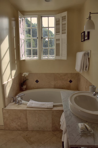 Modern tub, old fashioned windows looking out over Carmel rooftops