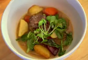 Braised oxtail kadu (stew) in coconut soy vinegar broth, smoked potatoes, mung bean noodles, carrots, pea tendrils