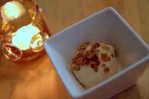 Salted coconut ice cream topped with toasted coconut and crumbled macadamia nuts, based on a Guam coconut treat cooked down with brown sugar
