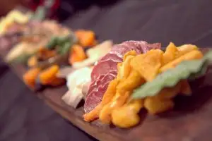 Enjoying a lovely charcuterie and cheese platter over dinner in the wine room/event space at Abbey Road