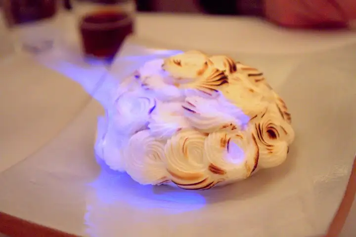 Eleven Madison's Baked Alaska set alight tableside