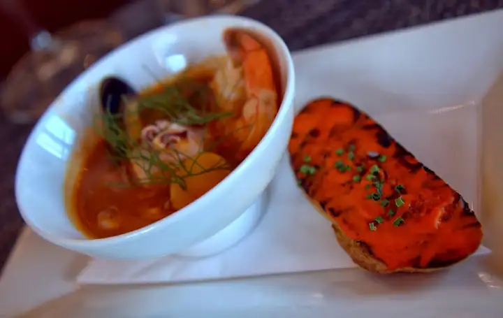 Bouillabaisse fish and shellfish of the day: bluenose seabass, mussels, calamari, shrimp, fingerling potatoes, fennel fronds with grilled crostini in piquillo pepper, garlic, olive oil, potato rouille paired with 2010 Cabernet Franc ($45) - vanilla, berry, oak