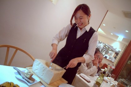 Our sweetheart of a waitress prepping the risotto in a giant wheel of Parmigiano Reggiano