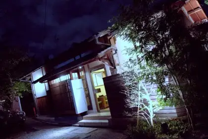 In a glowing house at the end of a driveway