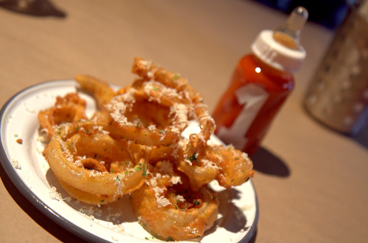 Starboard onion rings with ketchup in a bottle